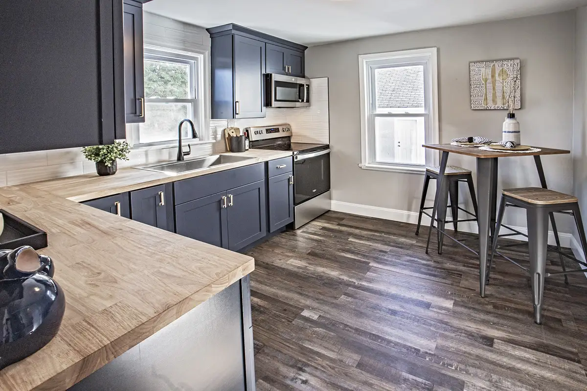 Kitchen remodel with dark cabinets and new floors.