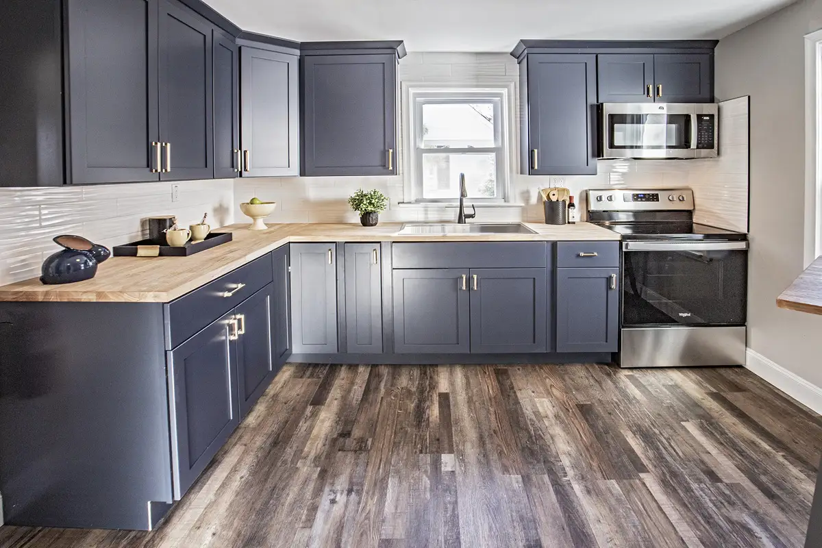 Kitchen with dark blue gray floor to ceiling cabinets.