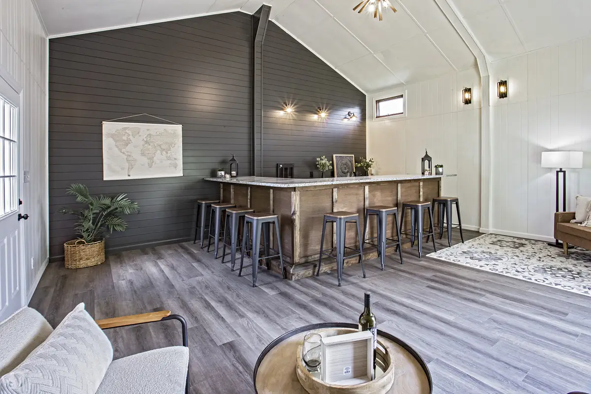Indoor bar against rich charcoal accent wall.