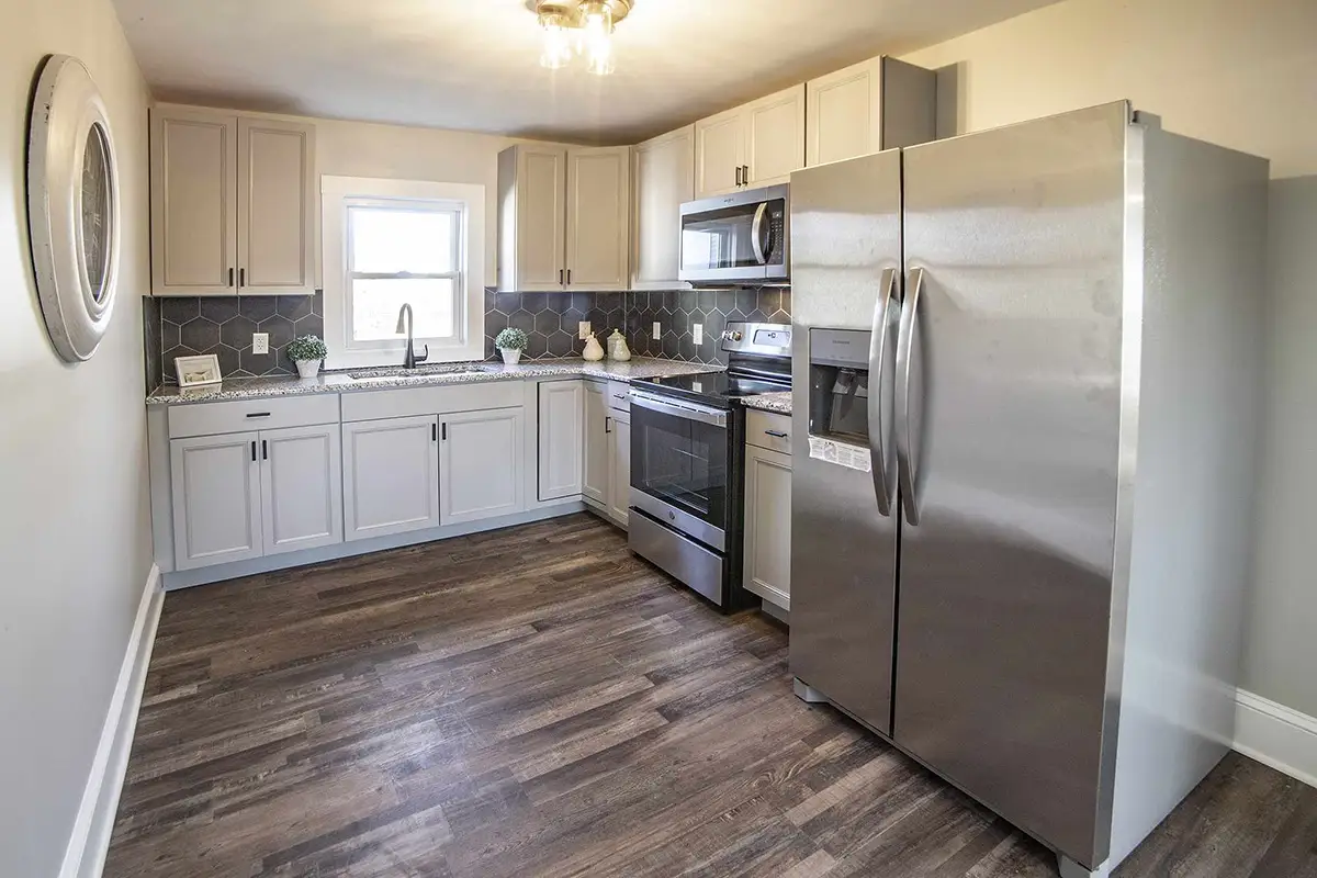 Kitchen with hardwood floors and stainless appliances.