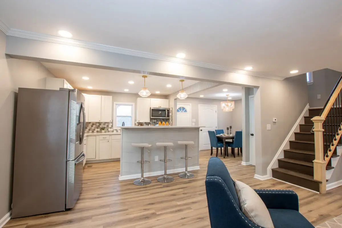 Kitchen with island and bright white cabinets.