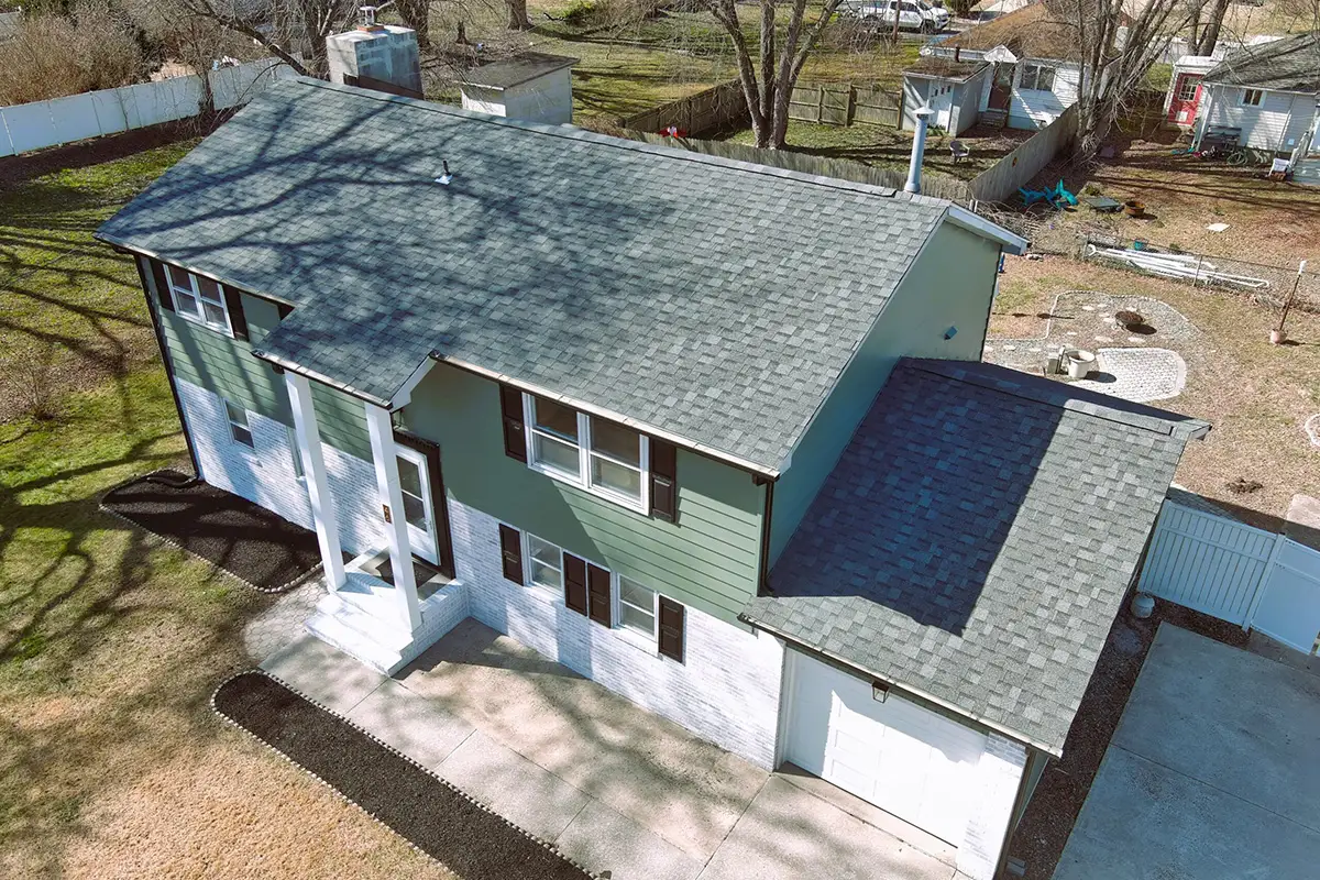 Aerial view of two tone green and white house.