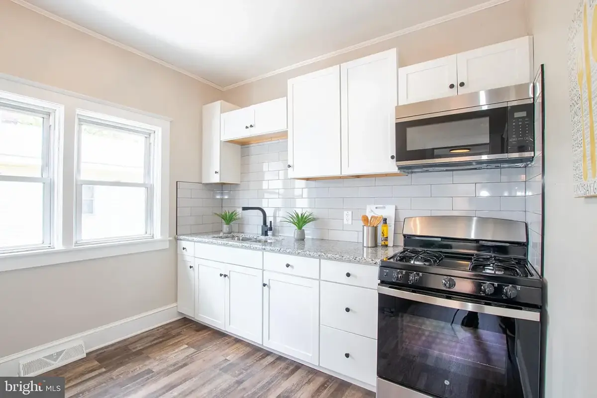 Kitchen with light cabinets and wood flooring.