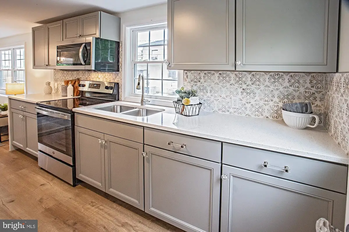 Beautiful kitchen cabinetry with ornate backsplash.