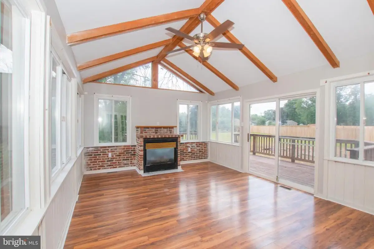 Inside living area with fireplace and ceiling beams.