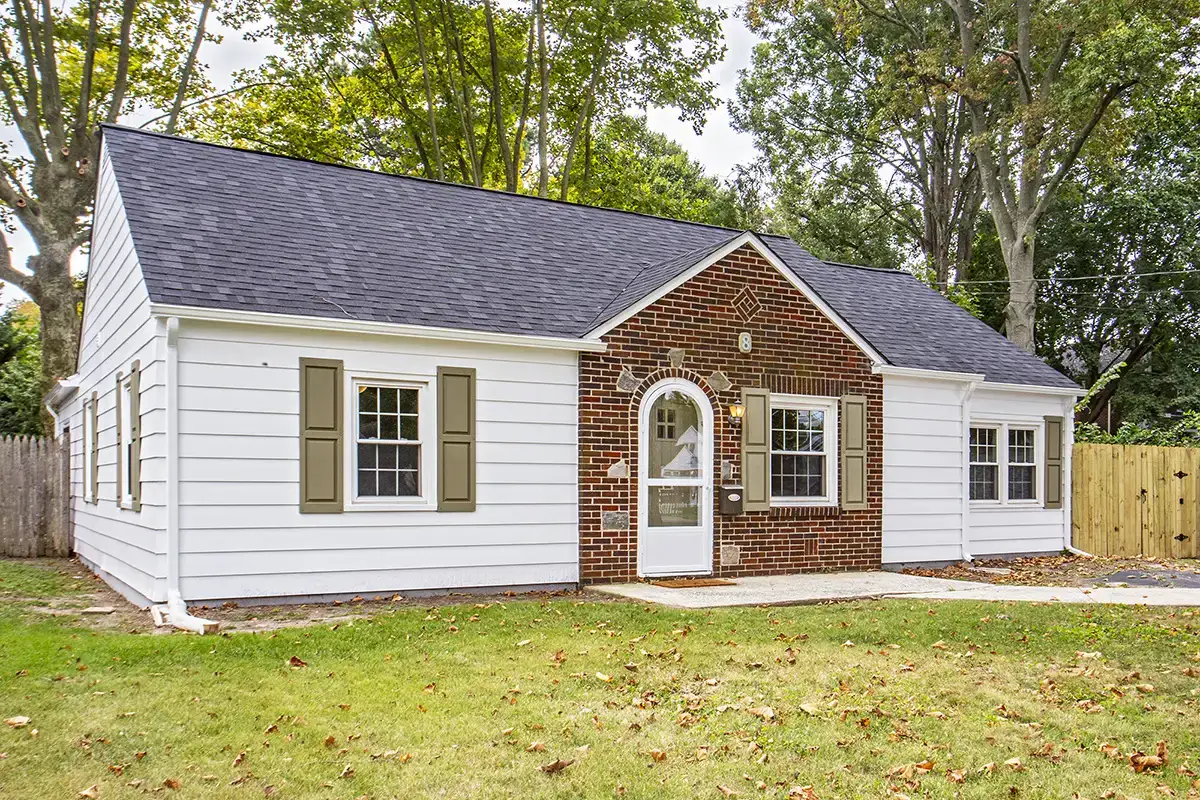White single story house with brown stone accented center section.
